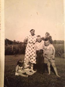Edeine with the kids, early 1950s.  Sandy and Jimmy sitting.  John and Tom standing.